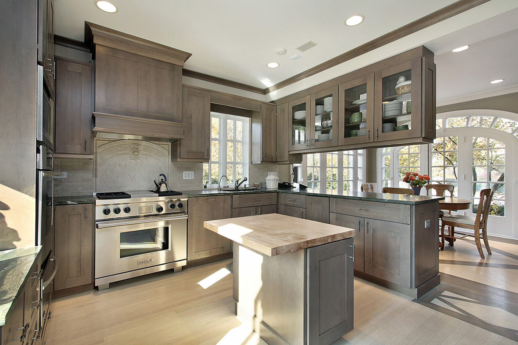 Kitchen in remodeled home with wood cabinetry and island